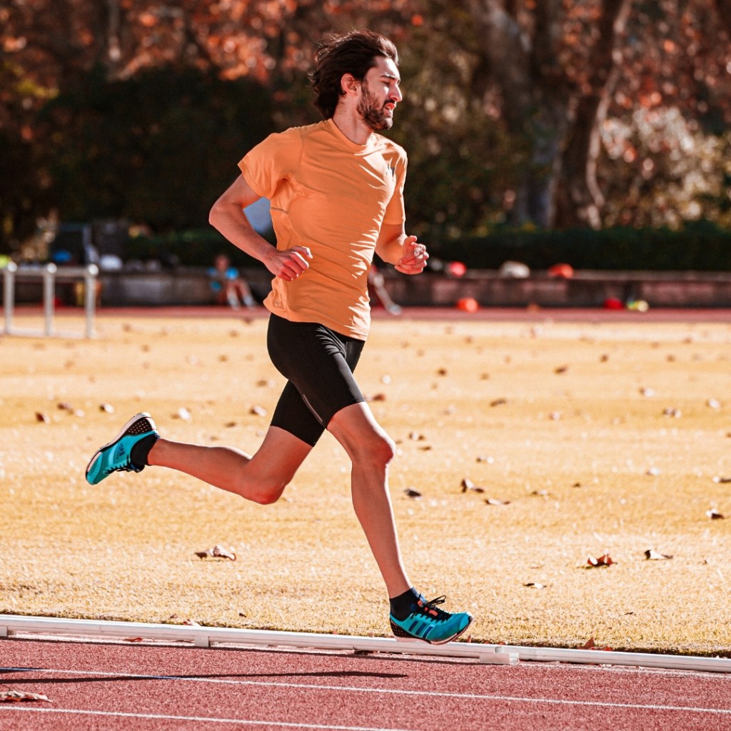 a man running on an athletics track
